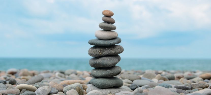 I am sitting on a pebbly beach